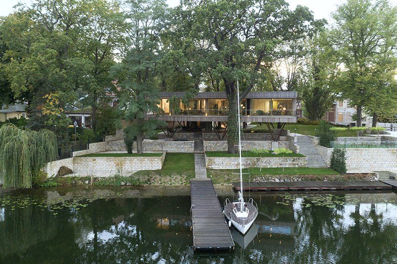 Timber house blending into nature on Potsdam lakeside