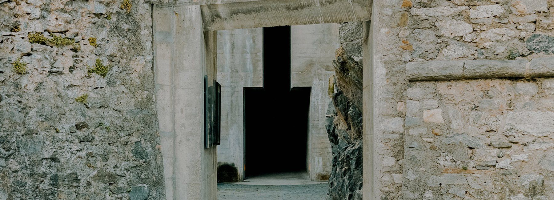 Medieval rock wall with a Brutalist addition