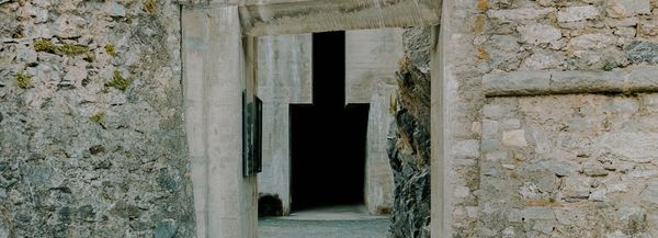 Medieval rock wall with a Brutalist addition